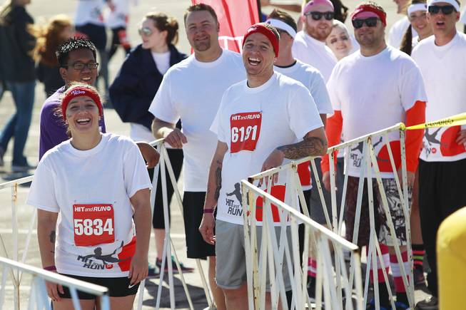 Participants laugh at others while waiting to take on an obstacle during the Hit and Run 5k Saturday, March 1, 2014 at Sam Boyd Stadium. The Hit and Run 5k, a fun run with various obstacles to navigate, is being held or planned in two dozen cities across the country.
